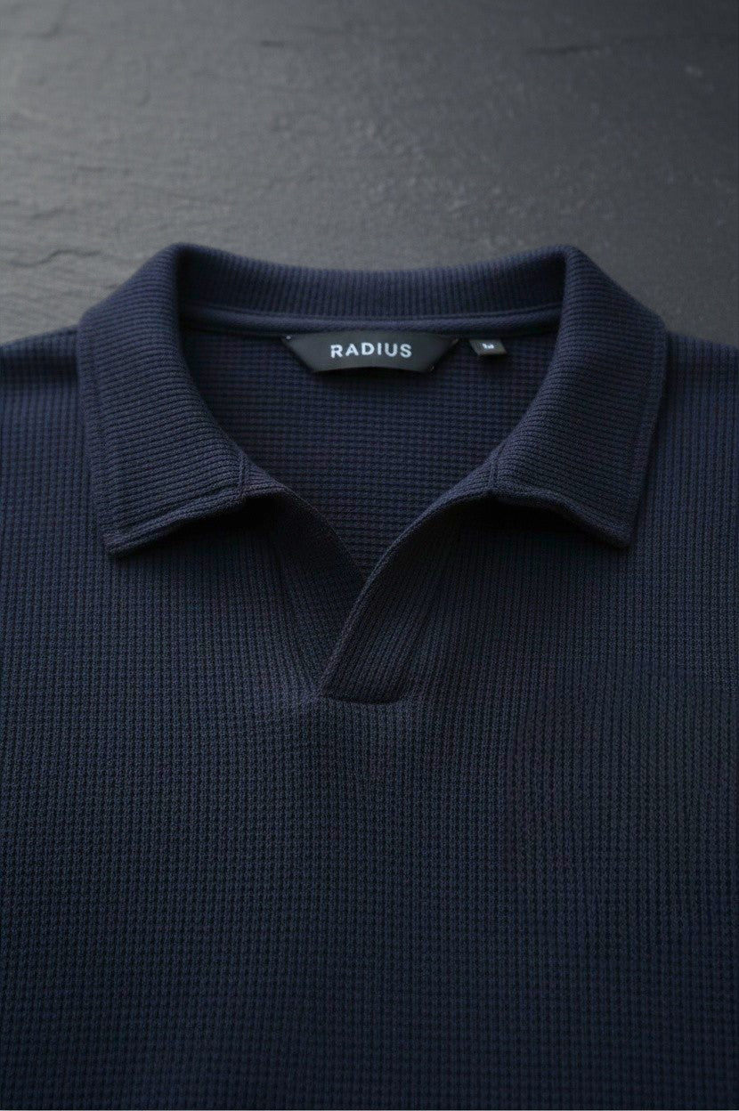 RADIUS midnight navy waffle-knit polo shirt with a modern placket-less V-neck and integrated collar.
