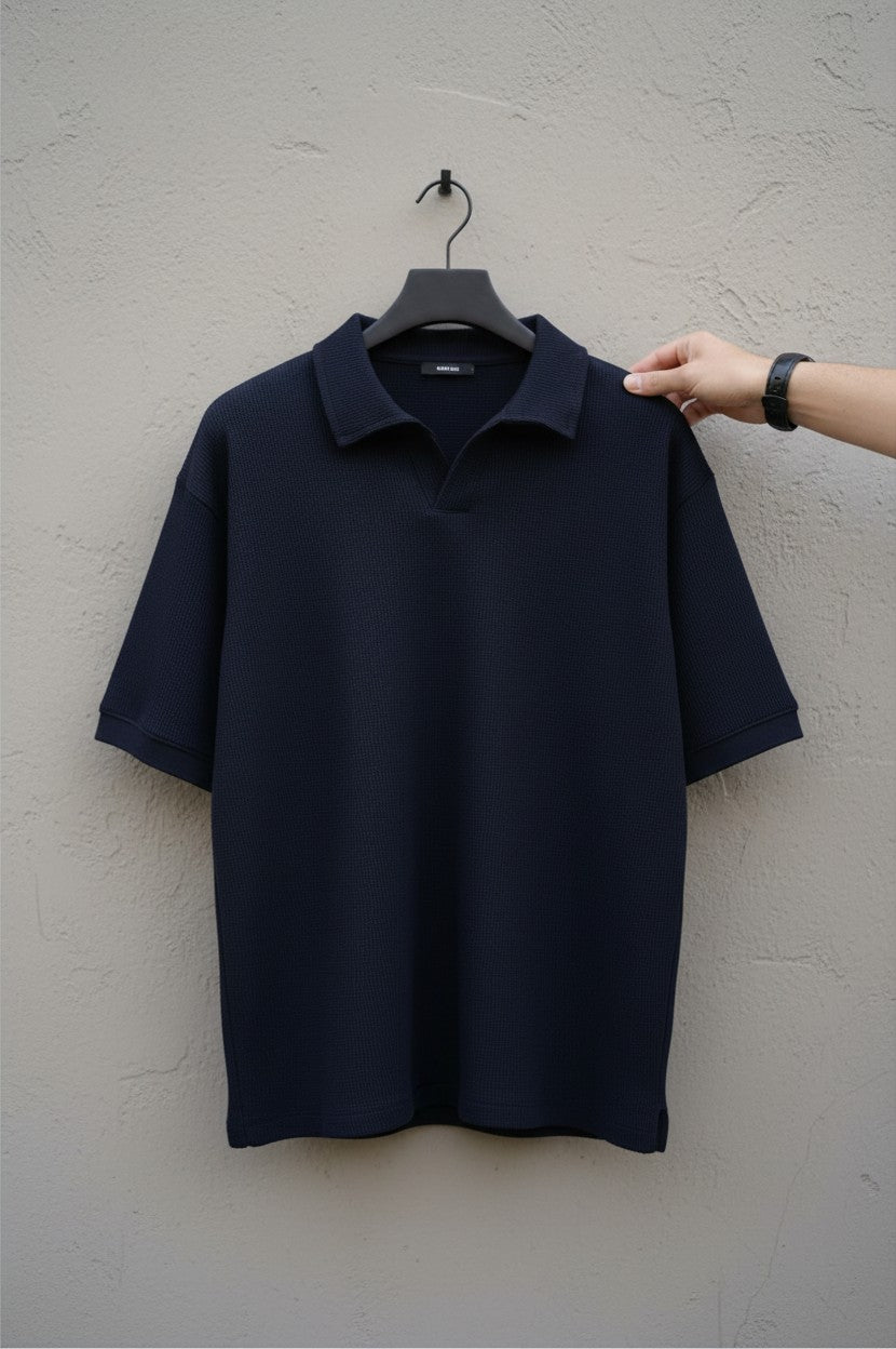 RADIUS midnight navy waffle-knit polo shirt with a modern placket-less V-neck and relaxed fit on a hanger.