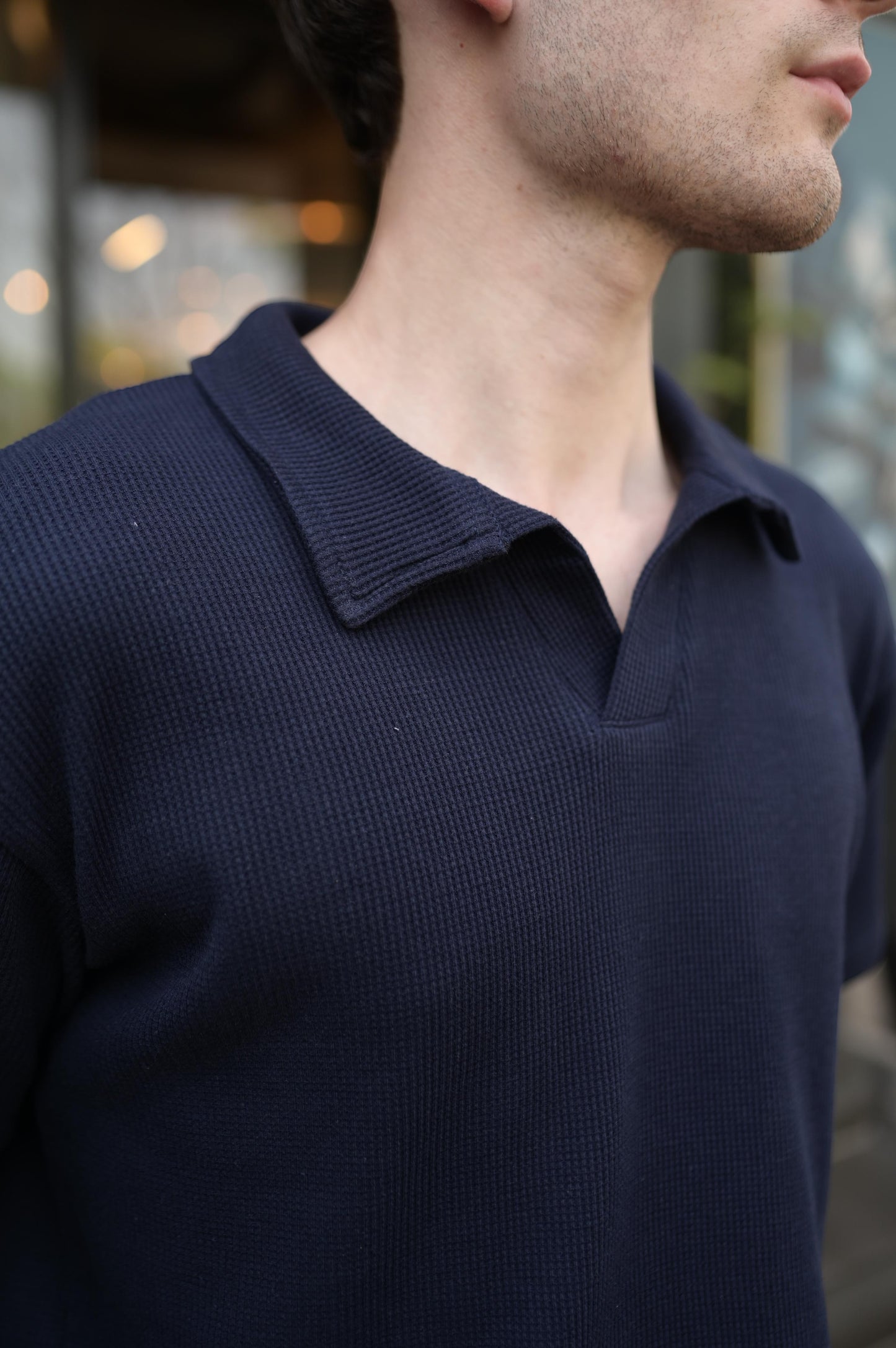 RADIUS midnight navy waffle-knit polo shirt with a modern placket-less V-neckline and integrated collar.